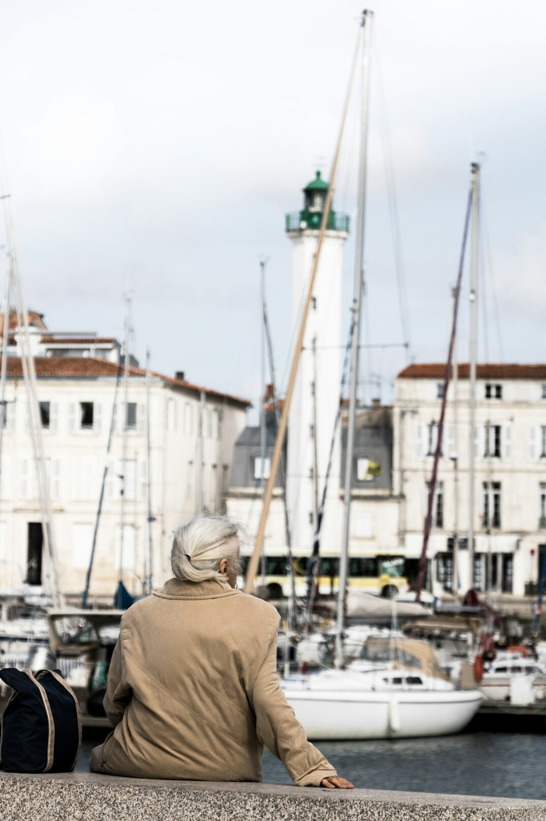 Portrait of a German man of sixty-eight with white hair in a harbor setting